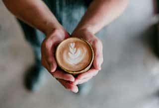 person holding coffee cup